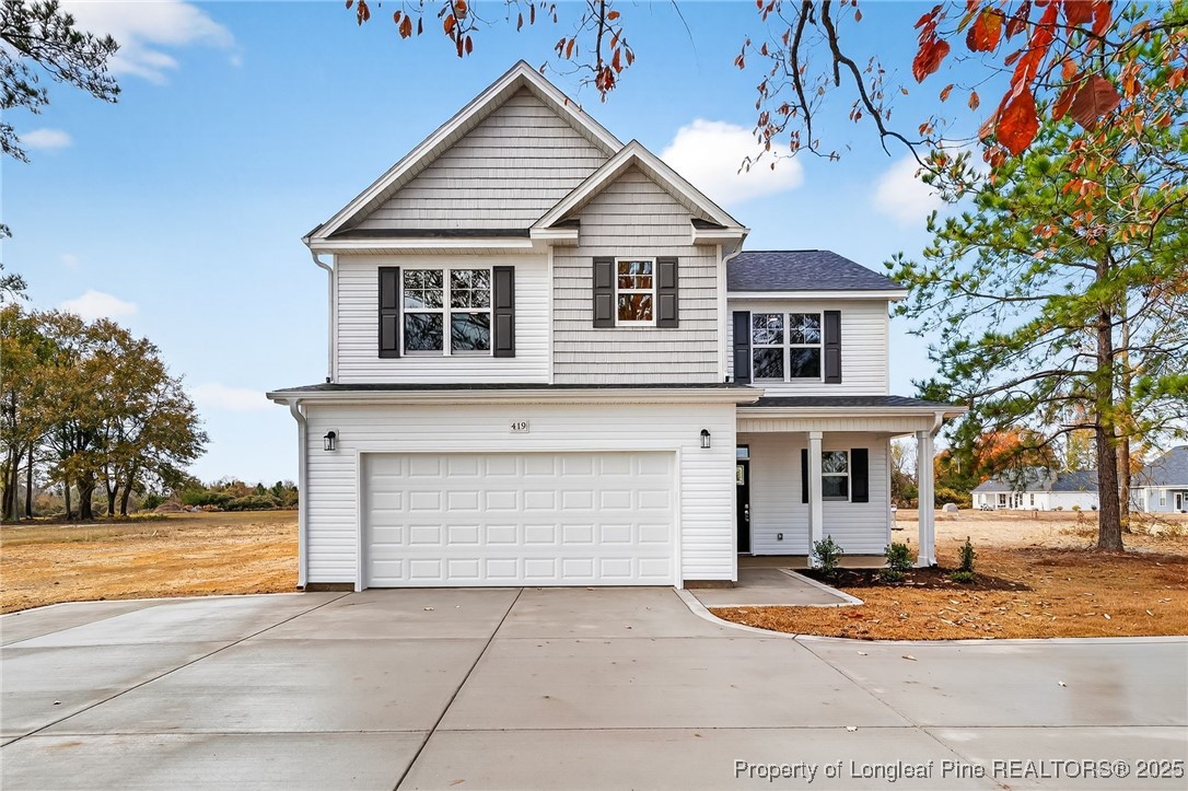 419 Delmore Road Autryville, NC 28318 - Photo 2 of 34 a front view of a house with a yard and garage