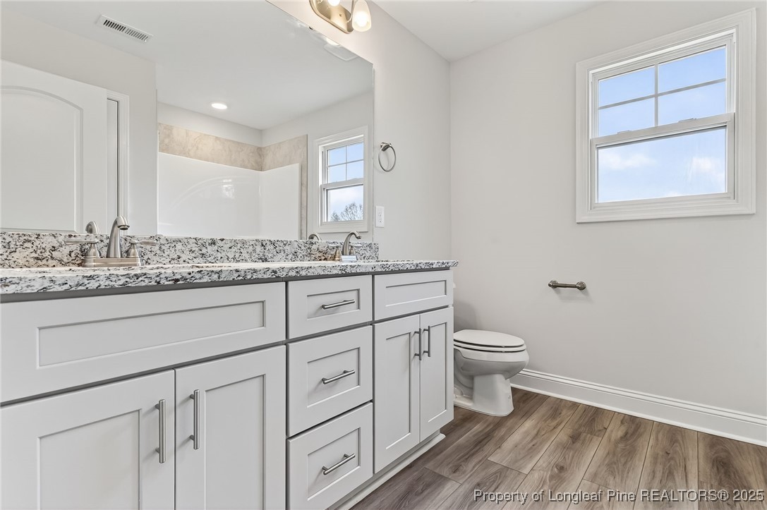 419 Delmore Road Autryville, NC 28318 - Photo 26 of 34 a bathroom with a granite countertop toilet sink and mirror