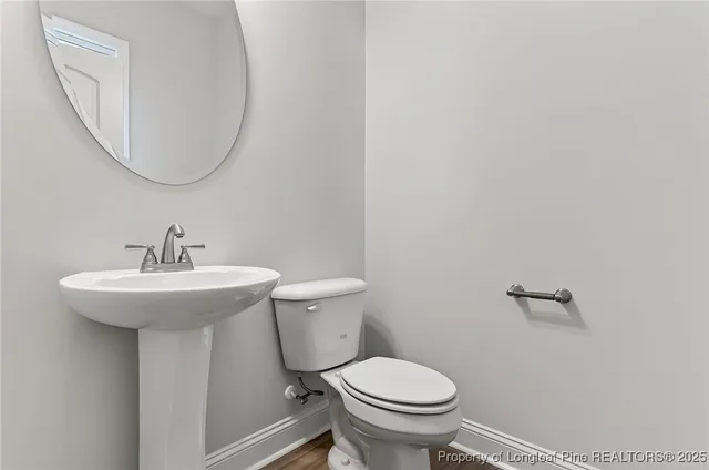 a view of a closet area with hardwood floor