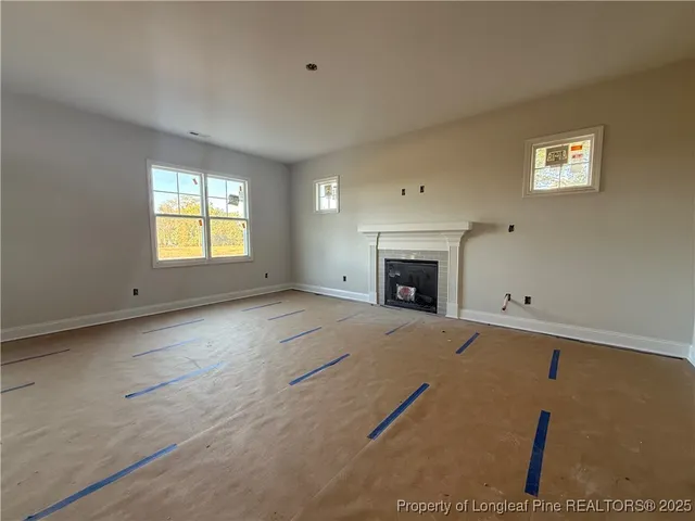 a view of empty room with a fireplace