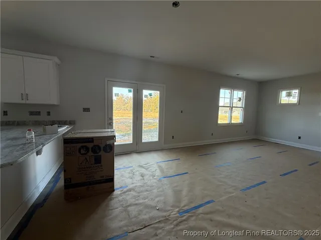 a kitchen with a stove and white cabinets