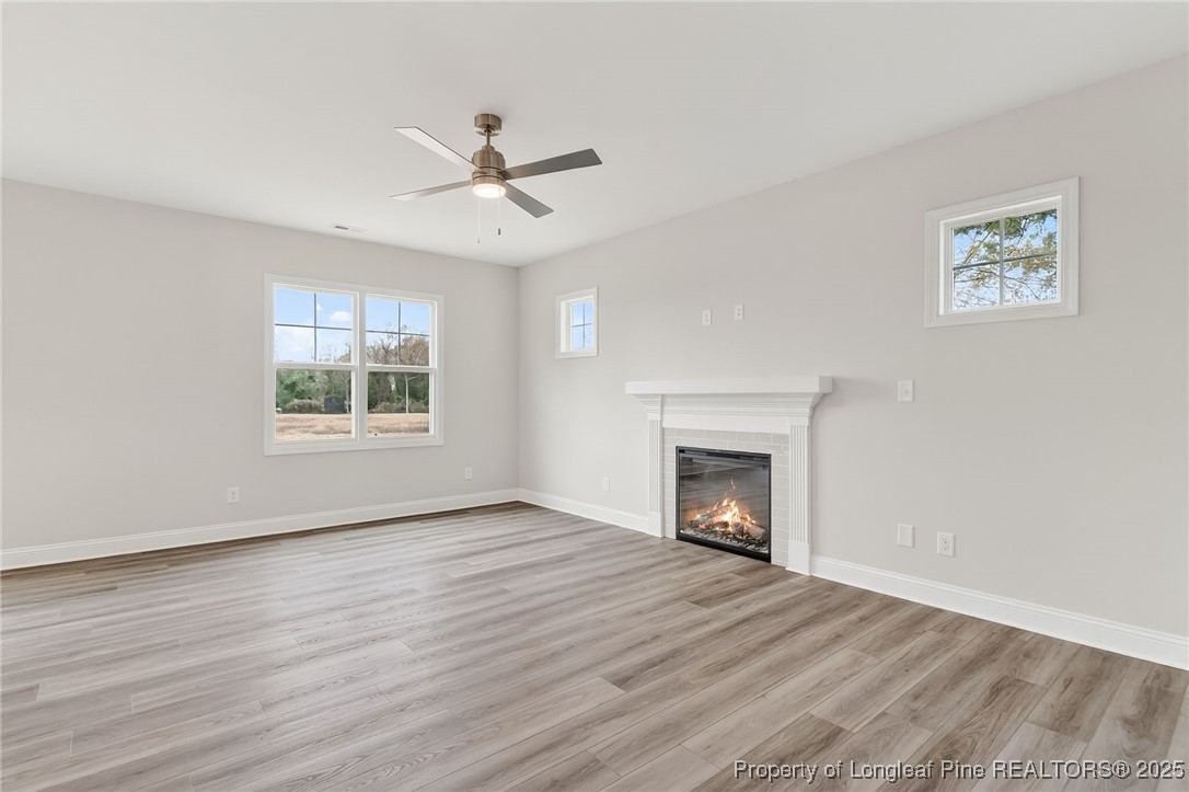 419 Delmore Road Autryville, NC 28318 - Photo 5 of 34 a view of an empty room with a window and fireplace