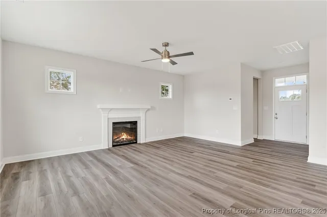 wooden floor fireplace and windows in a room