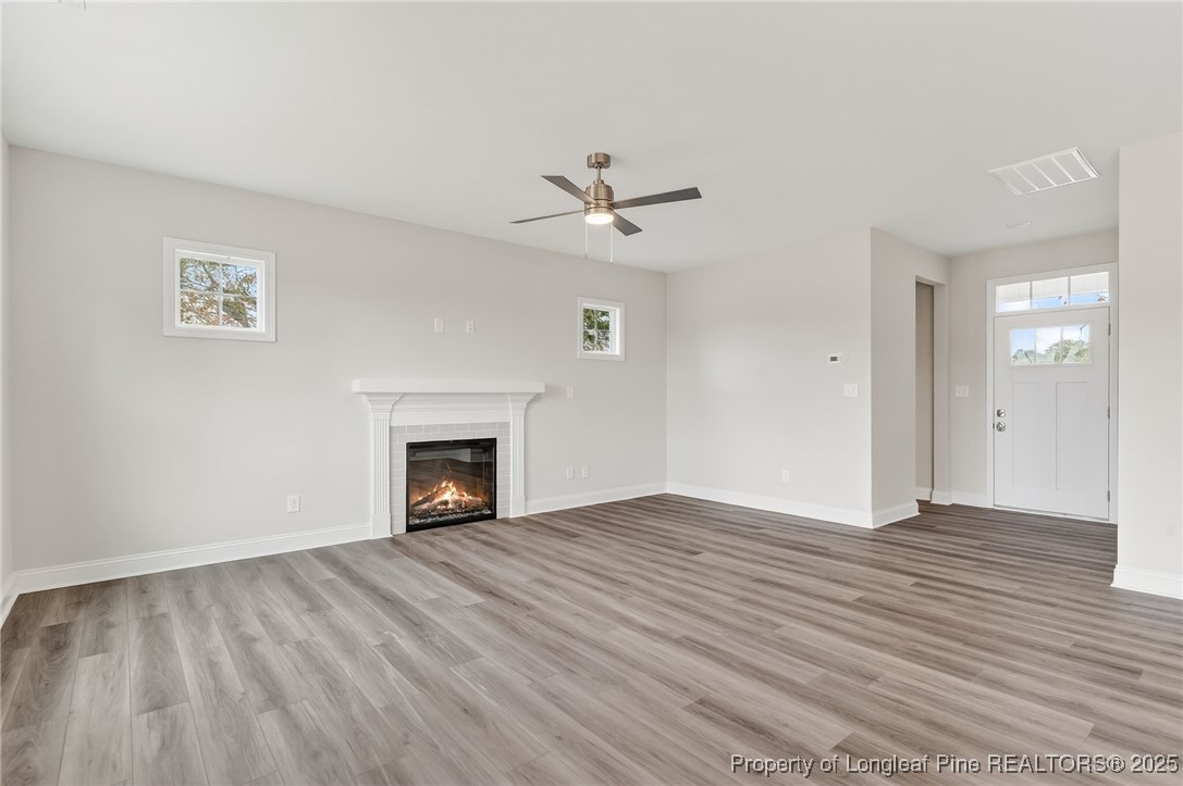 419 Delmore Road Autryville, NC 28318 - Photo 6 of 34 wooden floor fireplace and windows in a room