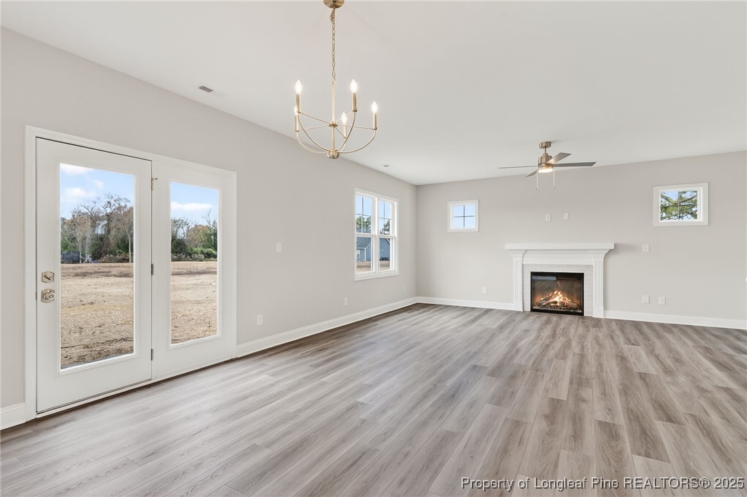 419 Delmore Road Autryville, NC 28318 - Photo 7 of 34 a view of an empty room with wooden floor fireplace and a window