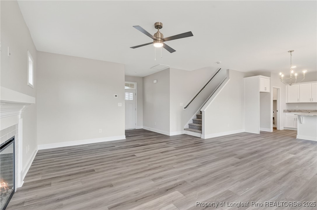 419 Delmore Road Autryville, NC 28318 - Photo 9 of 34 a view of an empty room with wooden floor and a ceiling fan