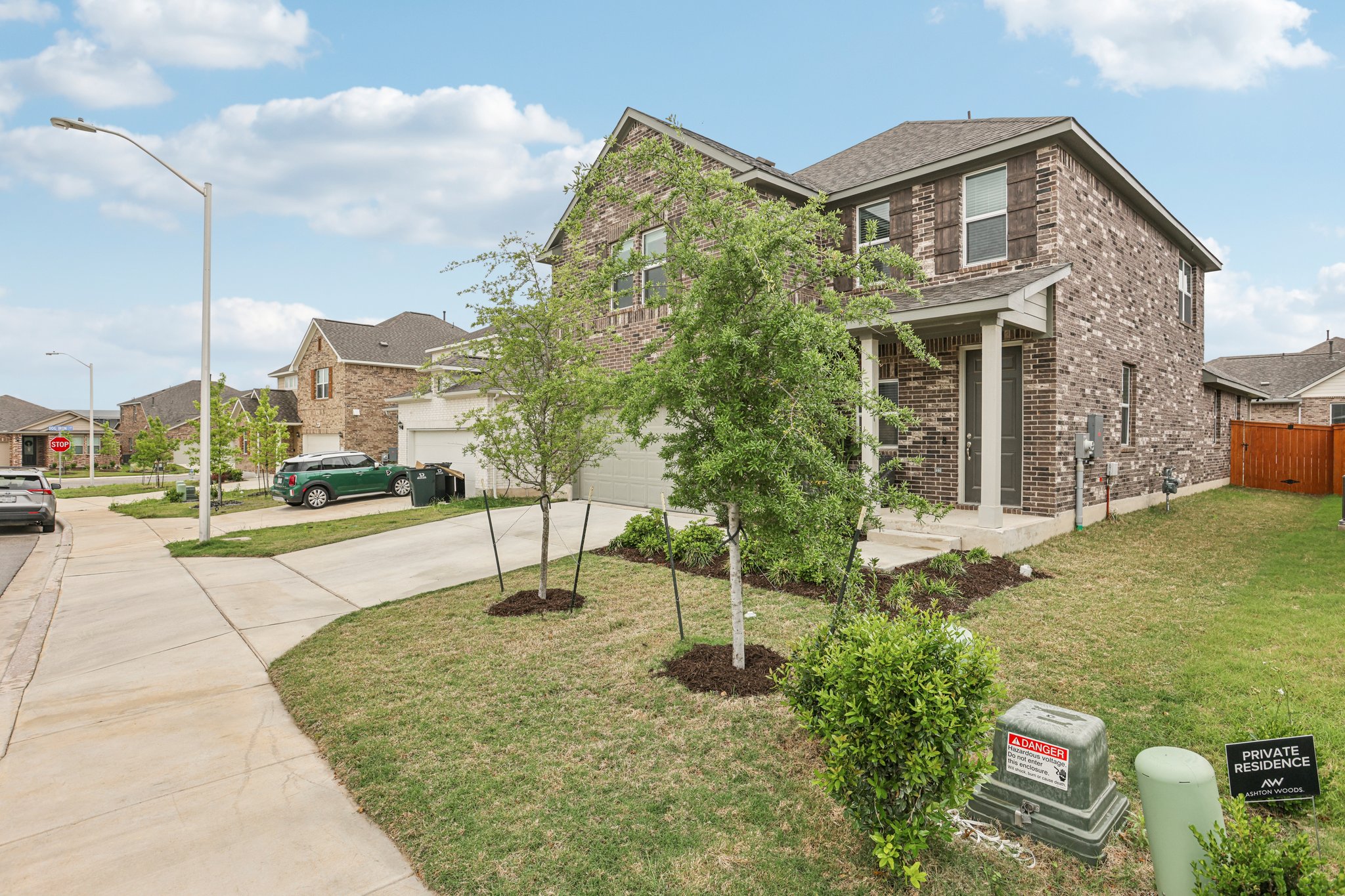 204 Swinging H Lane Georgetown, TX 78633 - Photo 38 of 39 The property features a brick exterior, a covered entryway, and a driveway