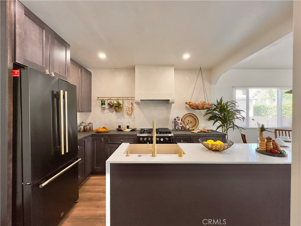 2907 South Ridgeley Drive Los Angeles, CA 90016 - Photo 15 of 37 a kitchen with a sink a counter and refrigerator