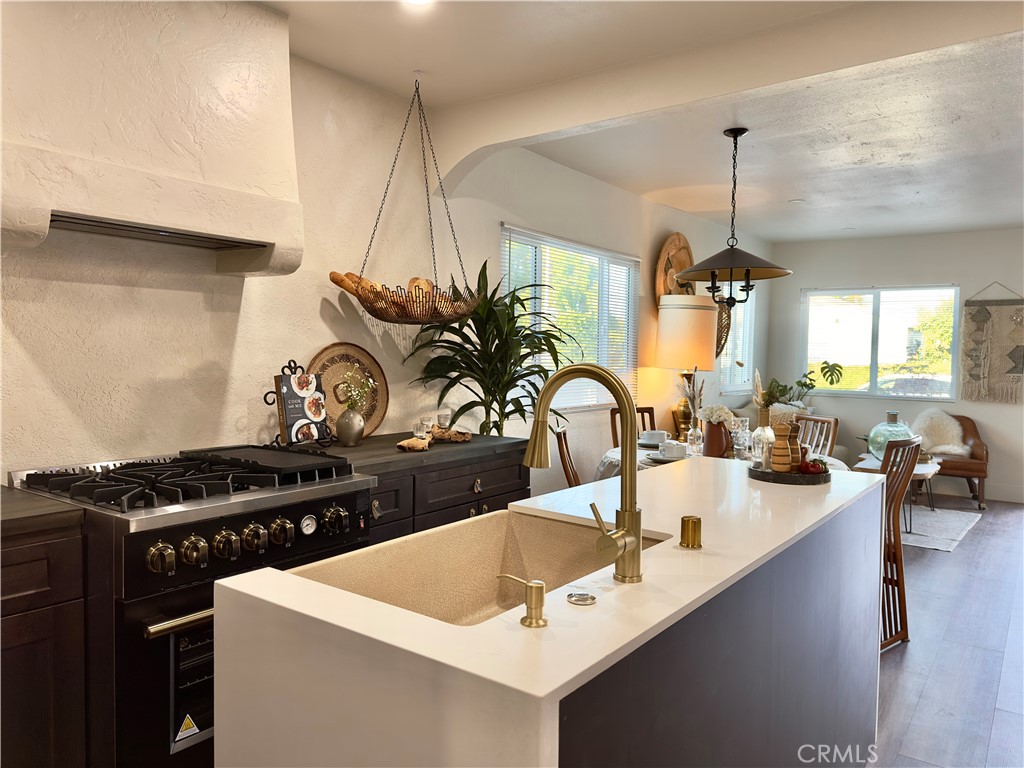 2907 South Ridgeley Drive Los Angeles, CA 90016 - Photo 16 of 37 a kitchen with sink a stove and cabinets