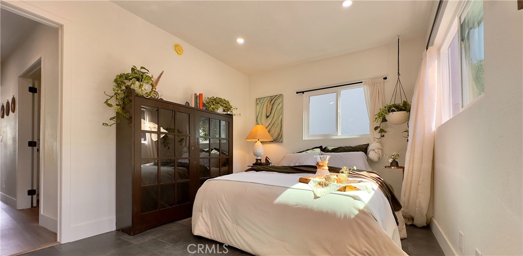 2907 South Ridgeley Drive Los Angeles, CA 90016 - Photo 21 of 37 a bedroom with a bed and a chandelier