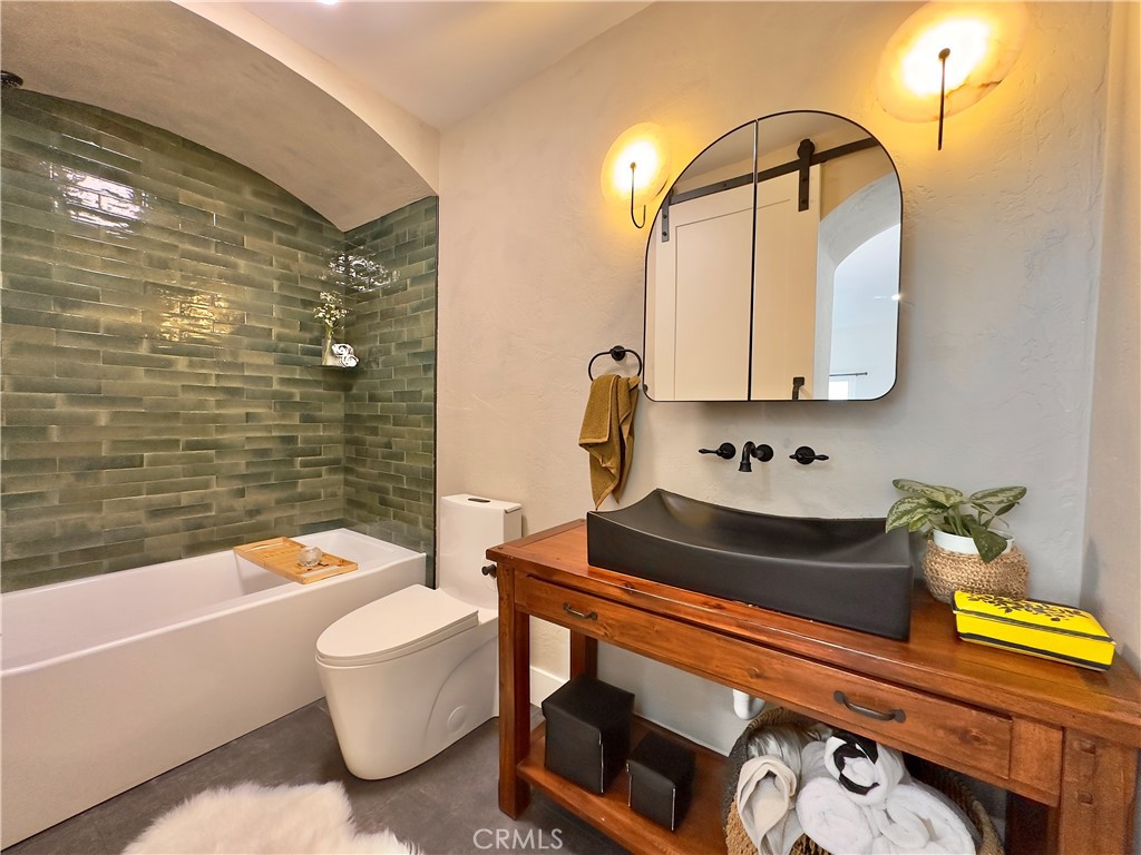 2907 South Ridgeley Drive Los Angeles, CA 90016 - Photo 23 of 37 a bathroom with a sink and a mirror