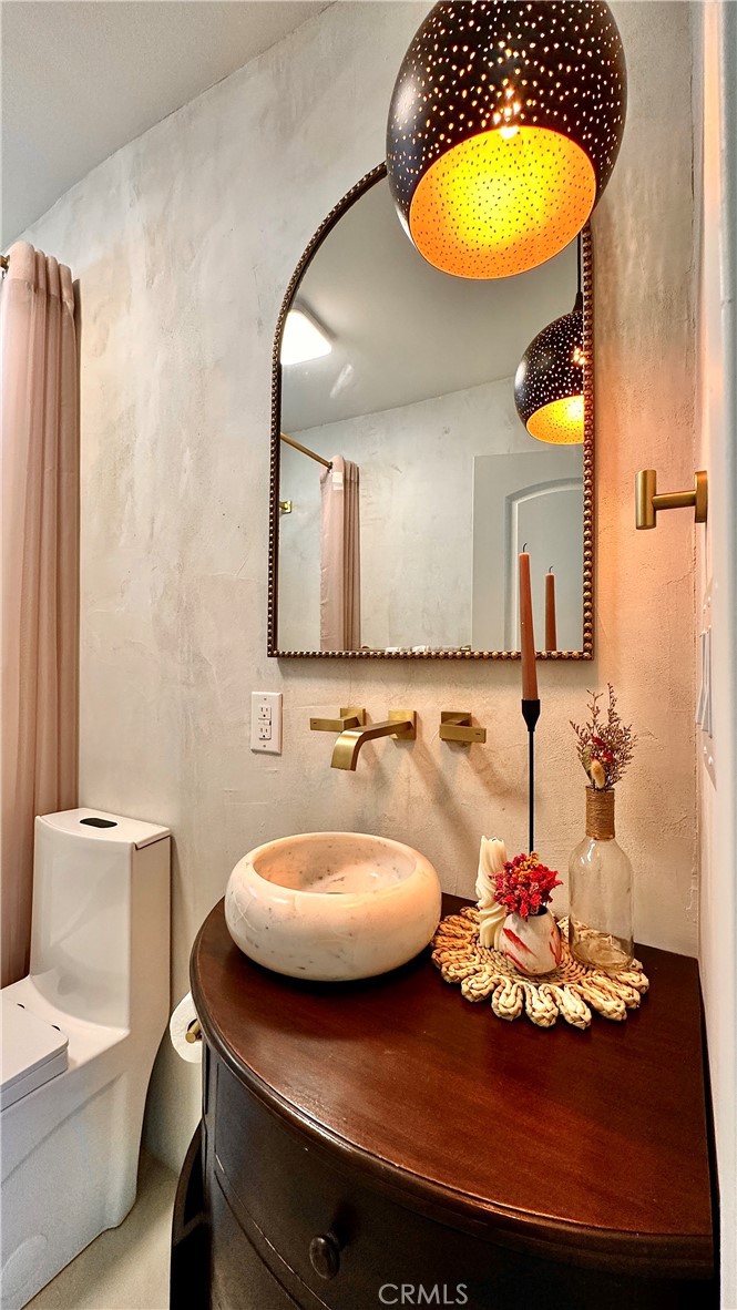 2907 South Ridgeley Drive Los Angeles, CA 90016 - Photo 28 of 37 a bathroom with a sink and a mirror