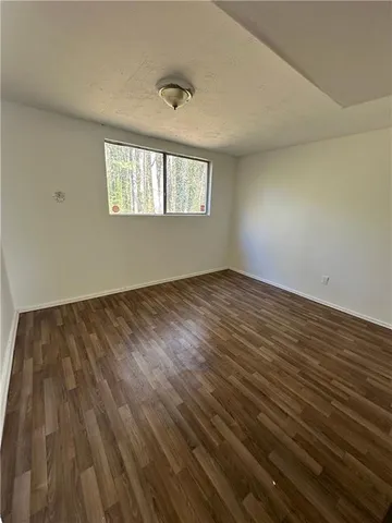 a view of an empty room and wooden floor
