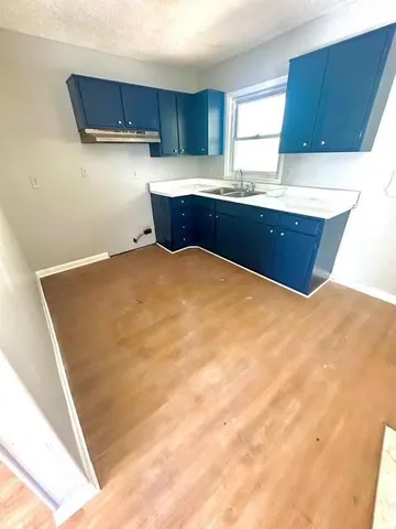 a kitchen with a sink and cabinets