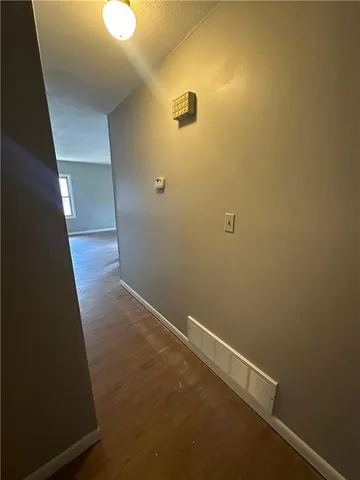 a view of hallway with wooden floor