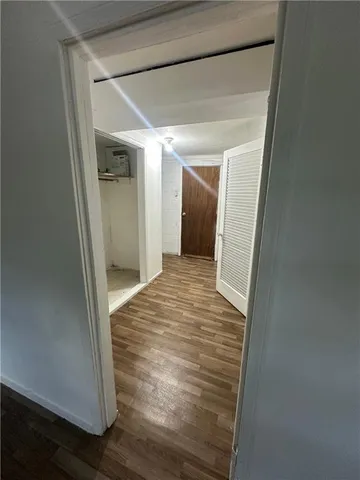 a view of empty room with wooden floor