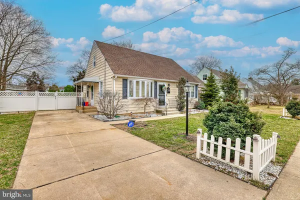 a view of house with outdoor space and tree in the background