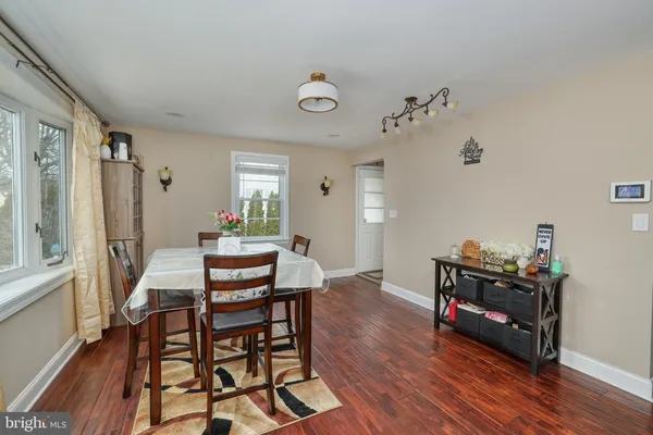 a view of a workspace with furniture and wooden floor