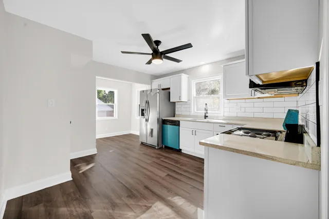 a kitchen with a stove cabinets and a refrigerator