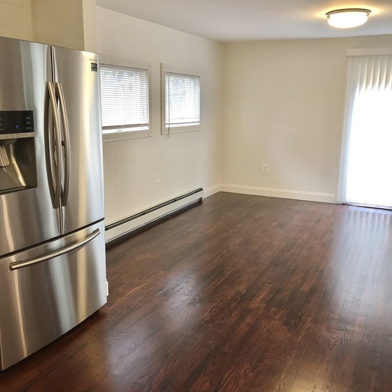 101 Parker Road Lancaster, MA 01523 - Photo 12 of 35 a view of an empty room with wooden floor and a window