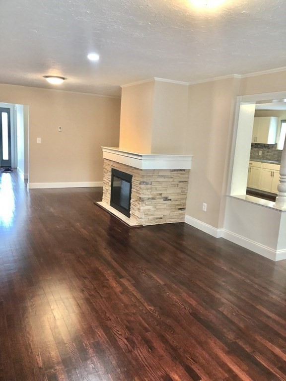 101 Parker Road Lancaster, MA 01523 - Photo 14 of 35 a view of an empty room with wooden floor and a window