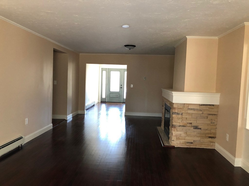 101 Parker Road Lancaster, MA 01523 - Photo 20 of 35 an empty room with wooden floor and windows