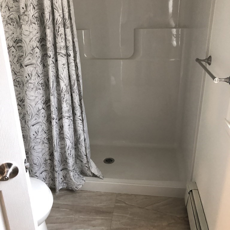 101 Parker Road Lancaster, MA 01523 - Photo 25 of 35 a bathroom with a shower curtain and a toilet