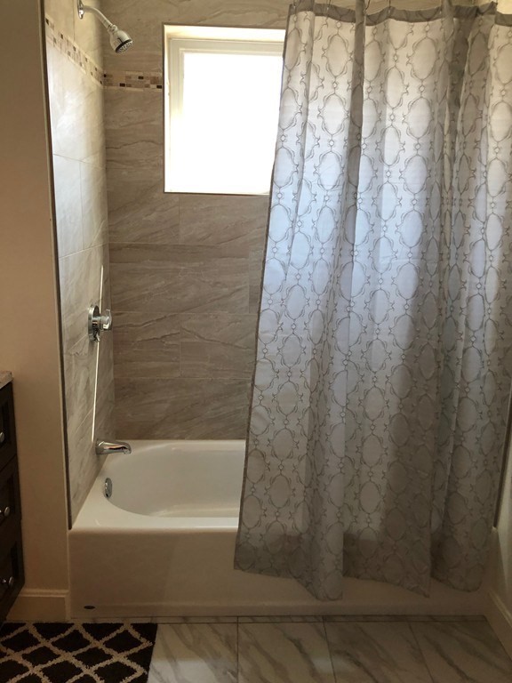 101 Parker Road Lancaster, MA 01523 - Photo 35 of 35 a bathroom with a bathtub and a shower