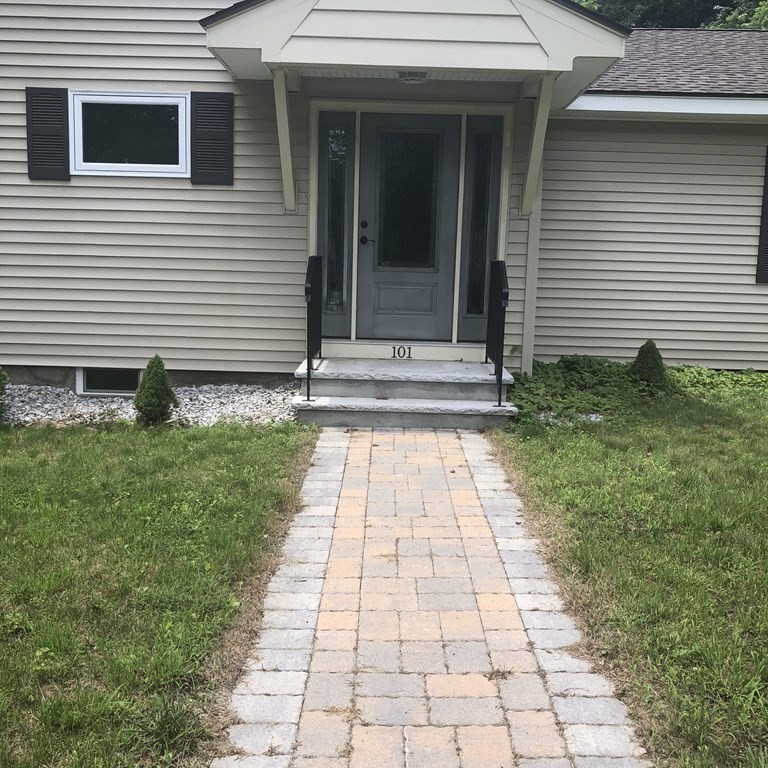 101 Parker Road Lancaster, MA 01523 - Photo 4 of 35 a view of a pathway both side of the house