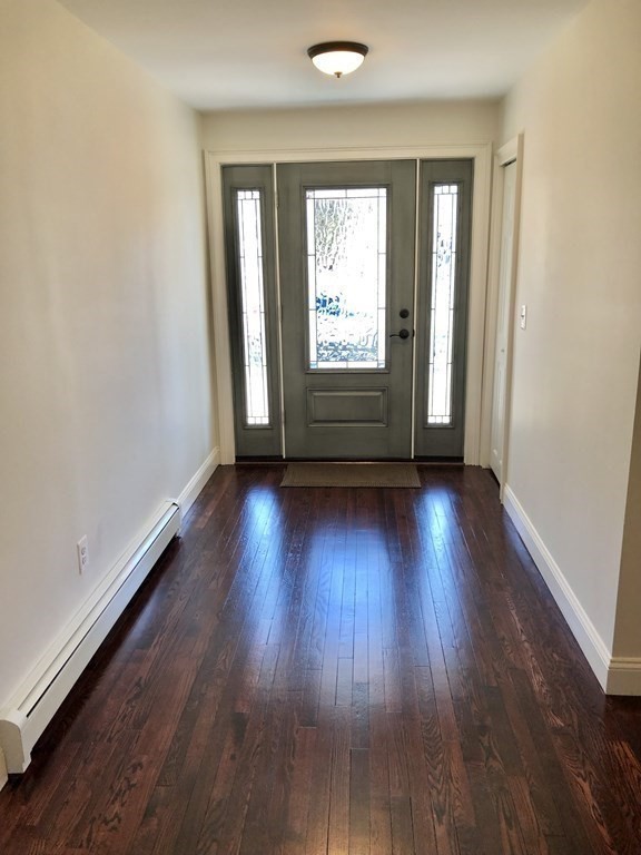 101 Parker Road Lancaster, MA 01523 - Photo 9 of 35 an empty room with wooden floor and windows