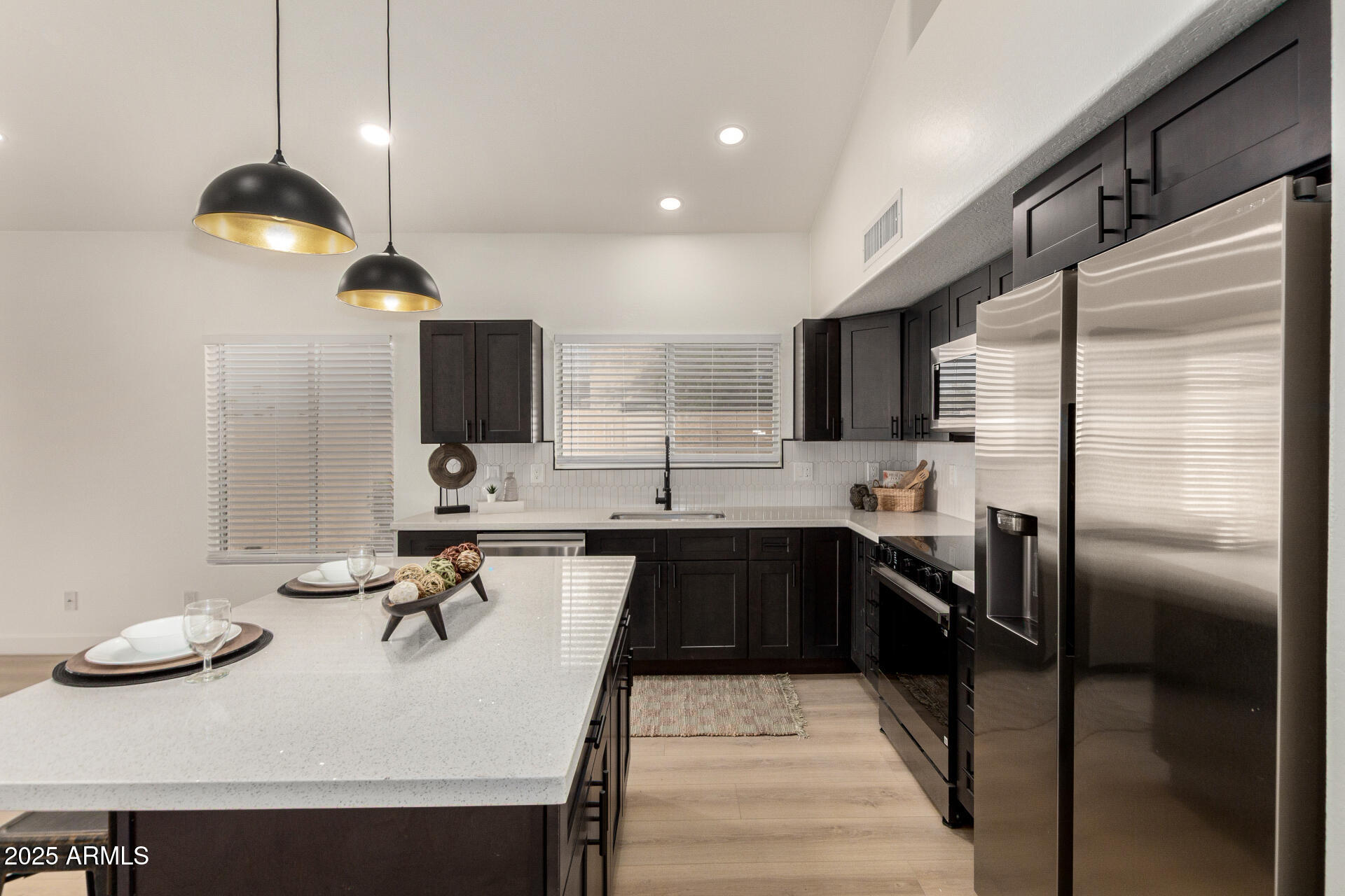 786 South Catalina Street Gilbert, AZ 85233 - Photo 5 of 34 a kitchen with kitchen island stainless steel appliances a sink and stove