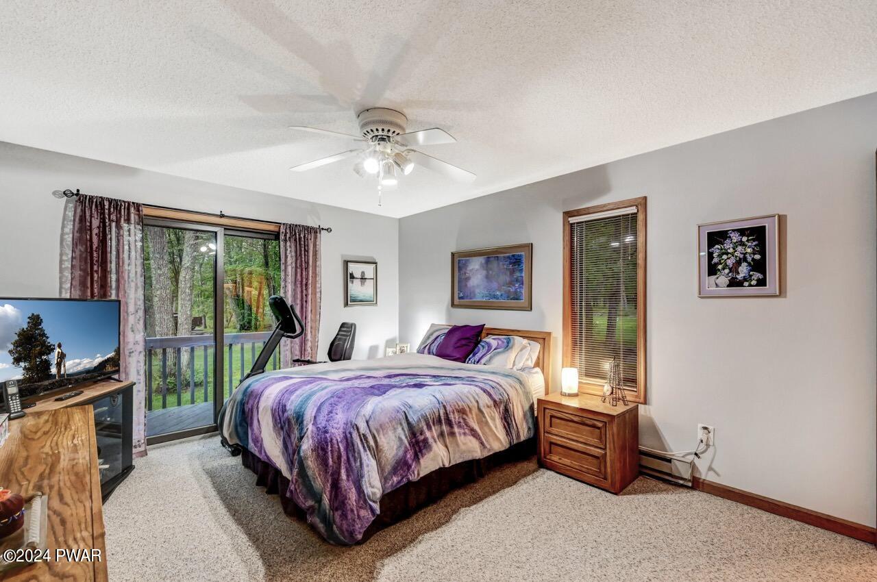 141 Maple Ridge Drive Hawley, PA 18428 - Photo 20 of 84 a bedroom with a bed a dresser next to a window