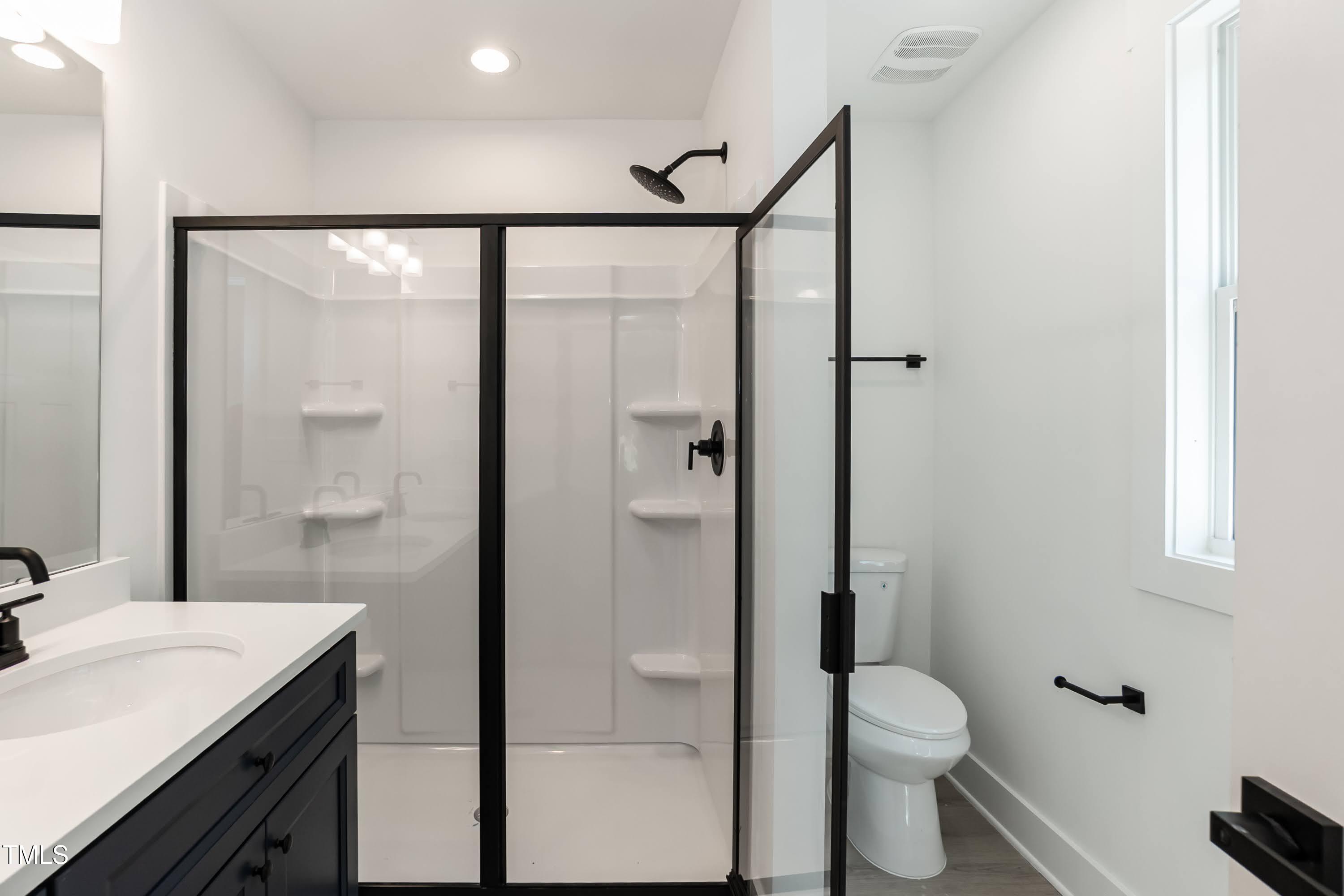 12 Gates Street Roxboro, NC 27573 - Photo 15 of 26 a bathroom with a granite countertop sink mirror vanity and toilet