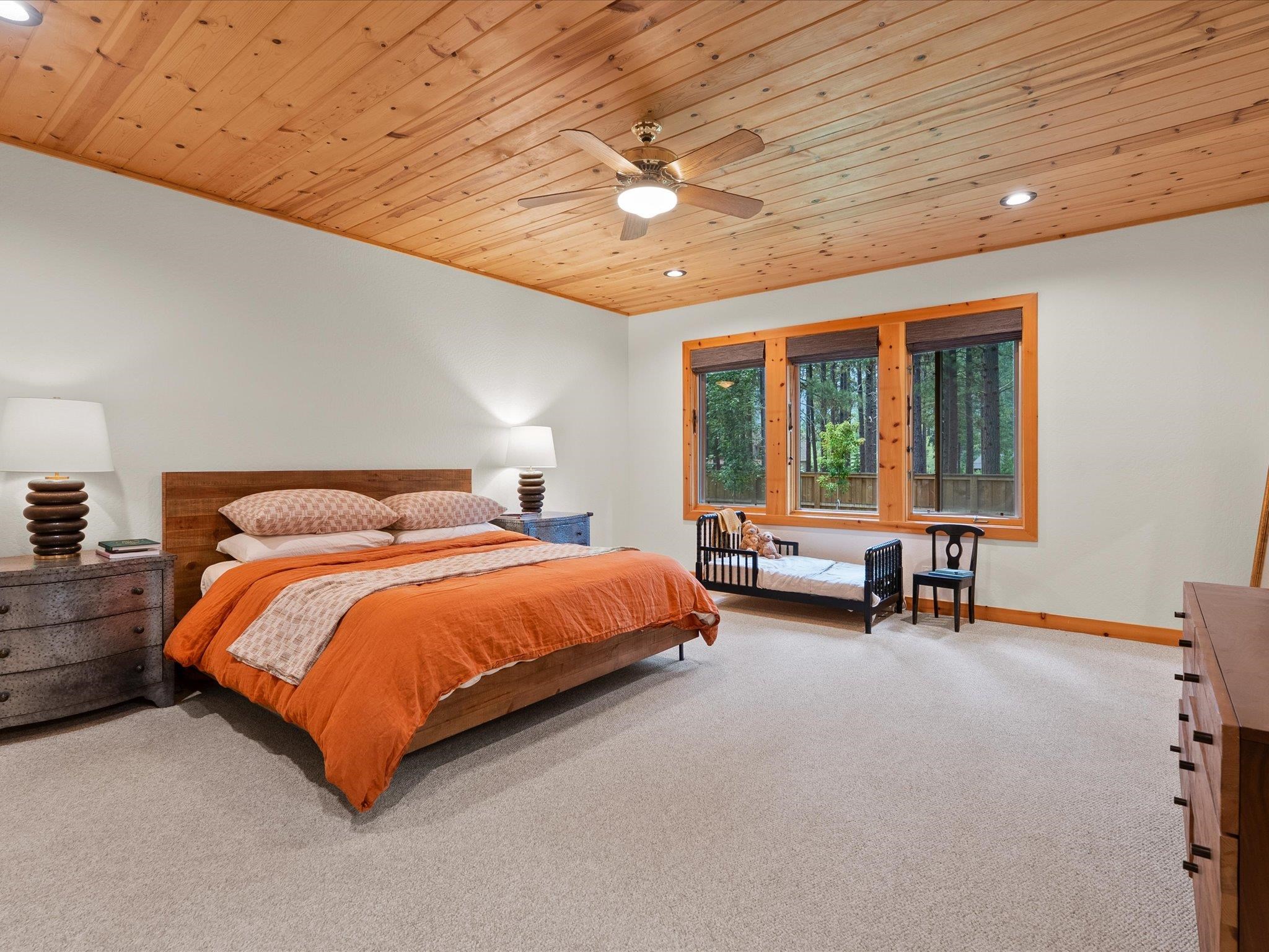 355 Quail View Circle Clio, CA 96106 - Photo 30 of 48 a bed sitting in a spacious bedroom next to a window