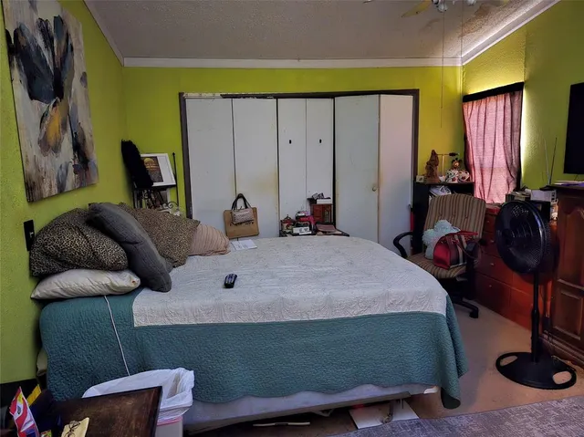 a bedroom with bed and wooden floor