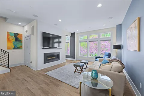 a living room with fireplace furniture and a flat screen tv