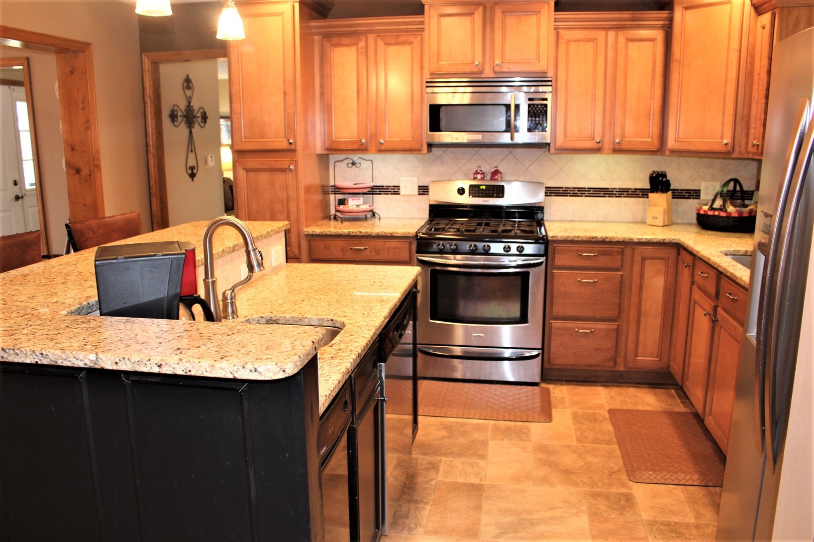 4229 Brush College Road Clinton, IL 61727 - Photo 8 of 43 a kitchen with stainless steel appliances granite countertop a sink stove and refrigerator