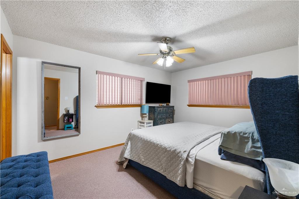 1804 Woodrow Street, Unit 184 Mission, TX 78572 - Photo 7 of 15 Bedroom featuring carpet flooring, a textured ceiling, and ceiling fan
