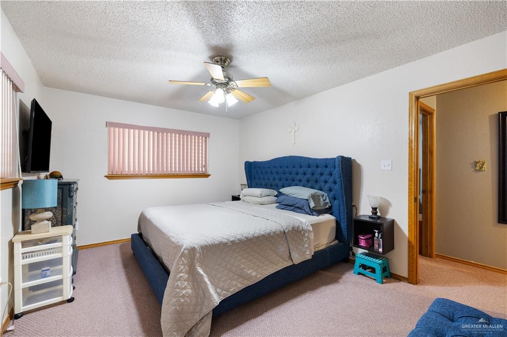 1804 Woodrow Street, Unit 184 Mission, TX 78572 - Photo 8 of 15 Carpeted bedroom featuring a textured ceiling and ceiling fan