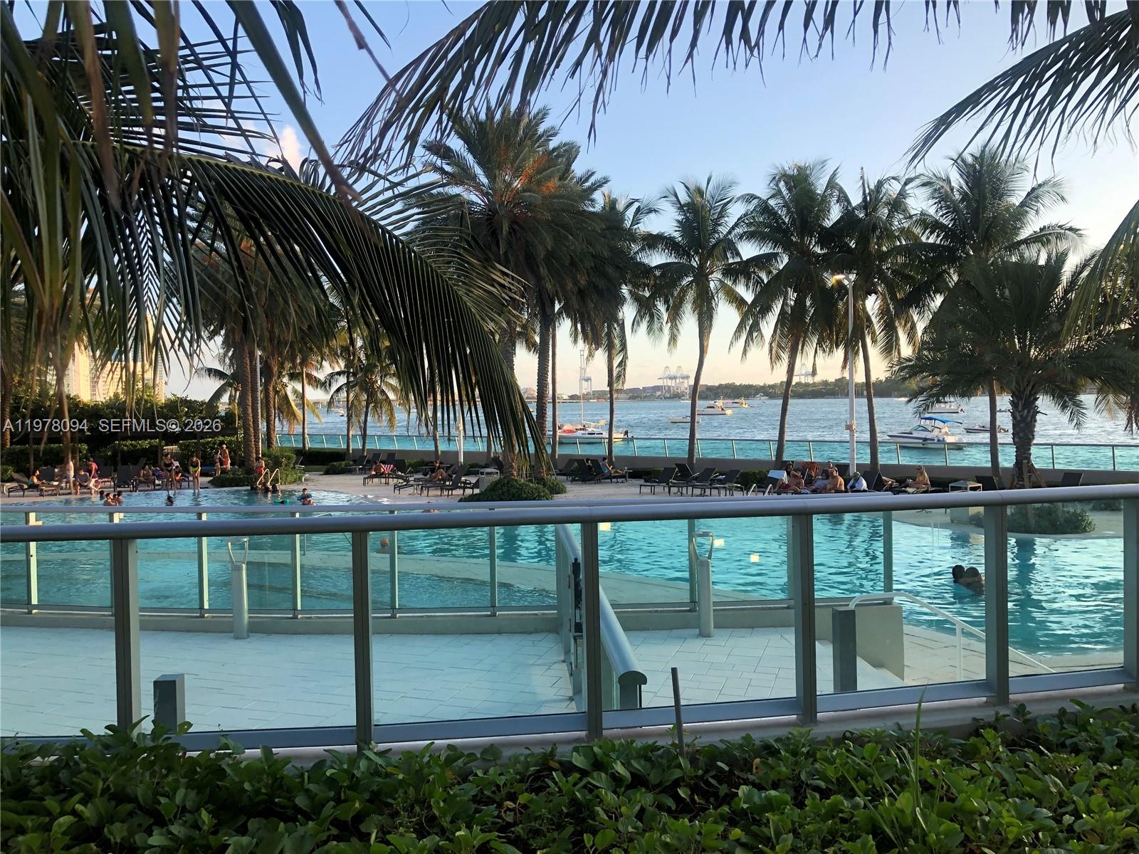 1500 Bay Road, Unit 524S Miami Beach, FL 33139 - Photo 19 of 27 a view of a swimming pool with a table and chairs