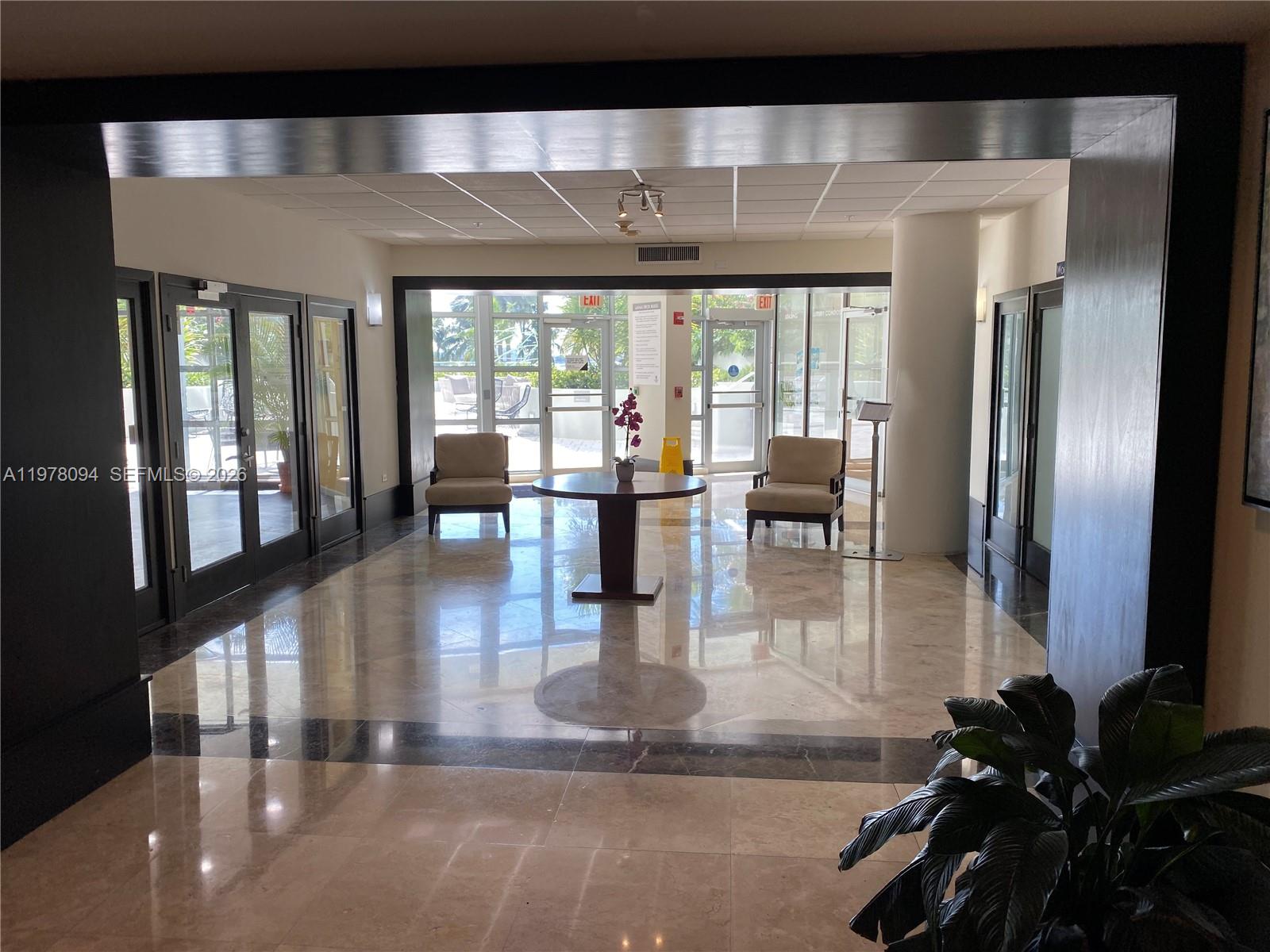 1500 Bay Road, Unit 524S Miami Beach, FL 33139 - Photo 22 of 27 a lobby with furniture and floor to ceiling window