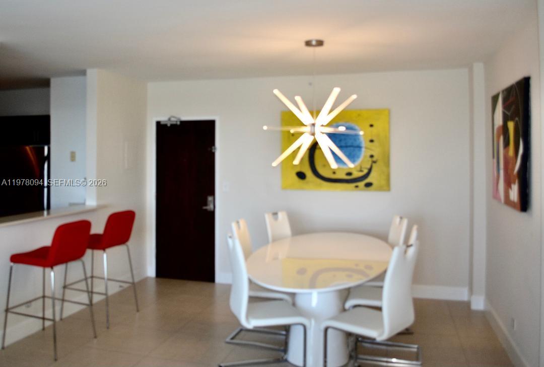 1500 Bay Road, Unit 524S Miami Beach, FL 33139 - Photo 6 of 27 a view of a dining room with furniture and wooden floor