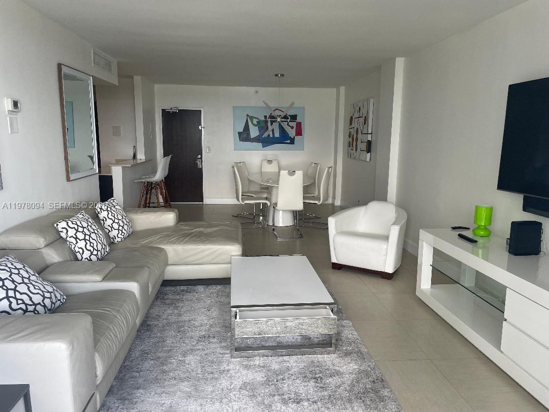 1500 Bay Road, Unit 524S Miami Beach, FL 33139 - Photo 8 of 27 a living room with furniture and a flat screen tv