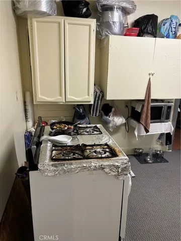 a kitchen with a stove a sink and a refrigerator