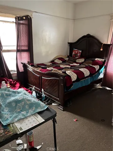 a bedroom with a bed and a window