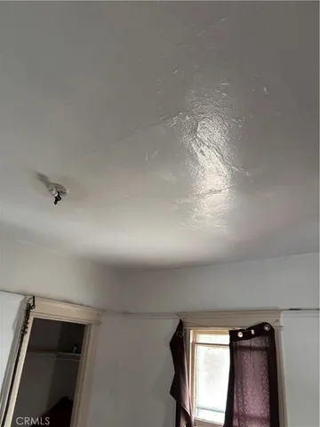 a bedroom with bed and window