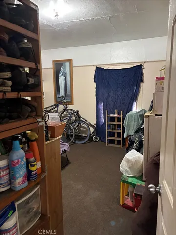 a bedroom with furniture and a flat screen tv