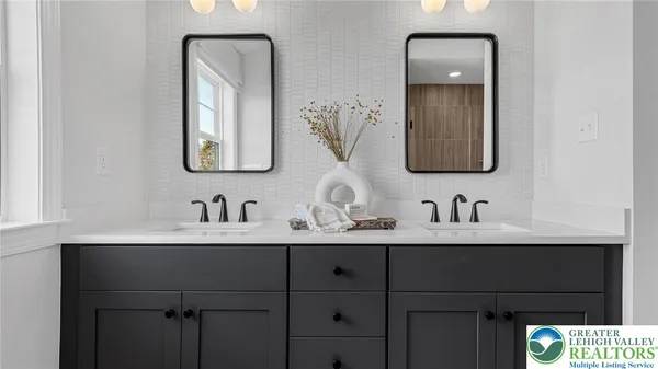 a bathroom with a double vanity sink and a mirror