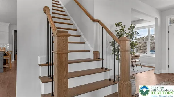 a view of entryway and hall with wooden floor