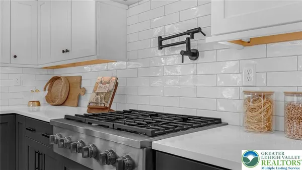 a kitchen with refrigerator and wooden floor